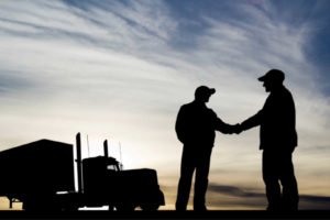 silhouette trucker shaking hands
