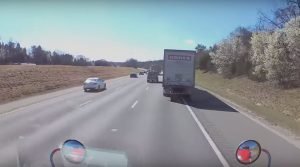 Dangerous trucker passes wide load on shoulder