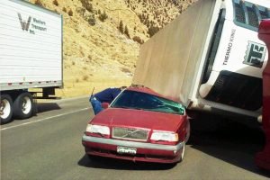 colorado tractor trailer blown over on top of volvo station wagon on I-70