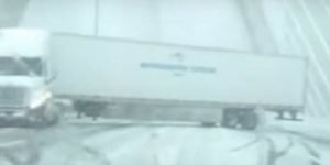 semi jackknifes in snow on Boston Zakim Bridge